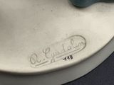 a close up of a figurine of a cat on a plate