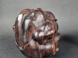 an image of a small carved object on a black surface