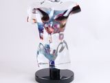 a glass sculpture of a male torso on a black stand