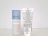 two bottles of lotion and a tube of lotion sitting on a table