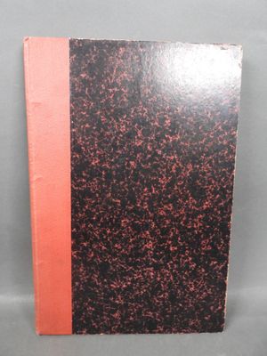 a black and red book sitting on top of a table