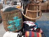 a pile of clothes and a chair in a warehouse