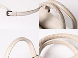 two photos of a white bag with a handle and a strap
