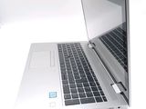 a laptop computer that is open on a white surface