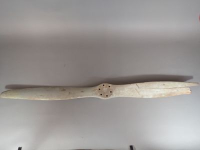 a small propeller on the wall next to a smaller propeller on the wall