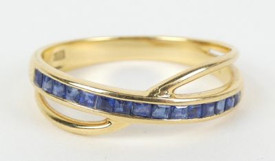 un gros plan d'une bague en or sertie de saphirs bleus