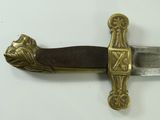a close up of a sword on a white surface