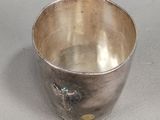 a silver cup that is sitting on a table