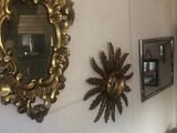 mirrors on the wall above a sink in a bathroom