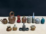 many different vases sitting on a table with a black background