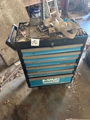 a blue tool box with tools on top of it in a garage