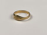 a close up of a gold ring on a white surface