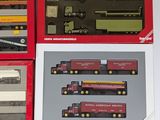 a lot of different model trains in boxes on the table
