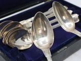 three spoons sitting in a case on a table