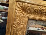 a picture of a gold picture frame in a room