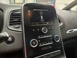 the dashboard of a car with a cell phone in the center of it