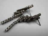 pair of black and white rhine earrings on a white surface
