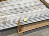 a large pile of steel rods on a pallet