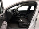 the interior of a car with the door open and the driver ' s seat down