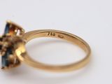 an image of a gold ring with a sapphire stone in the center