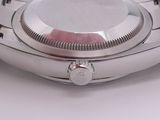 a close up of a watch on a white surface