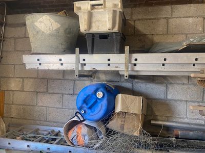 a blue bucket sitting on top of a shelf next to a blue bucket