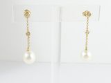 a pair of pearl and diamond drop earrings