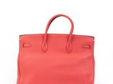 a red leather handbag on a white background