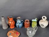 many different types of vases sitting on a table
