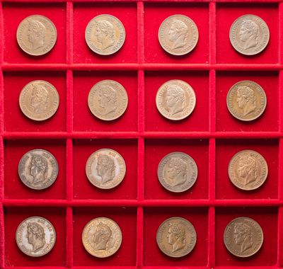 an image of a red display case filled with lots of silver coins