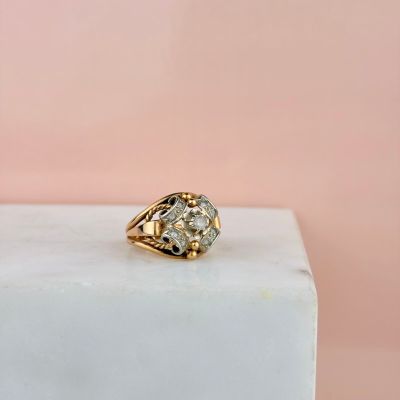 un gros plan d'une bague en diamant posée sur un bloc de marbre