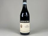 a bottle of red wine sitting on top of a table