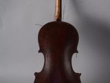 an old violin sitting on top of a white surface