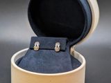 a box with a pair of earrings inside of it