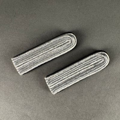 a pair of mop pads on a table with a gray background