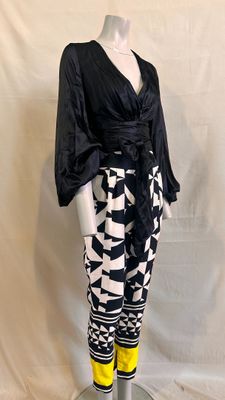 the mannequin is wearing a black and white outfit with yellow leggings