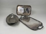 three pieces of silverware including a tray, spoon, and spoon rest