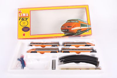 a toy train set in a box on a white surface