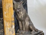 a bookend with a cat sitting on top of it