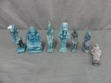 several statues of different sizes and shapes on a gray surface