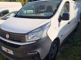 a white van parked in the grass next to a white van