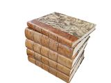 books stacked on top of each other on a white surface
