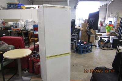 a refrigerator that is sitting in the middle of a room