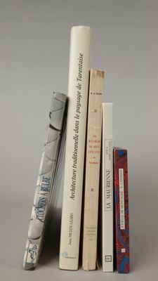 several books are stacked on top of each other on a table