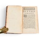 an open book with a gold hand resting on top of it