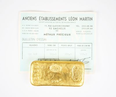 a gold bar sitting on top of a piece of paper