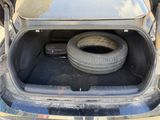 tire in the trunk of a car with a flat tire
