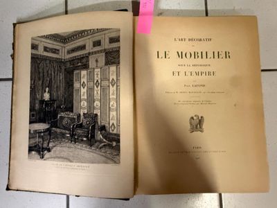an open book with a picture of a living room in it