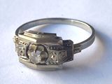 a silver ring with a stone in it on a white surface