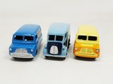 three toy cars sitting side by side on a white surface
